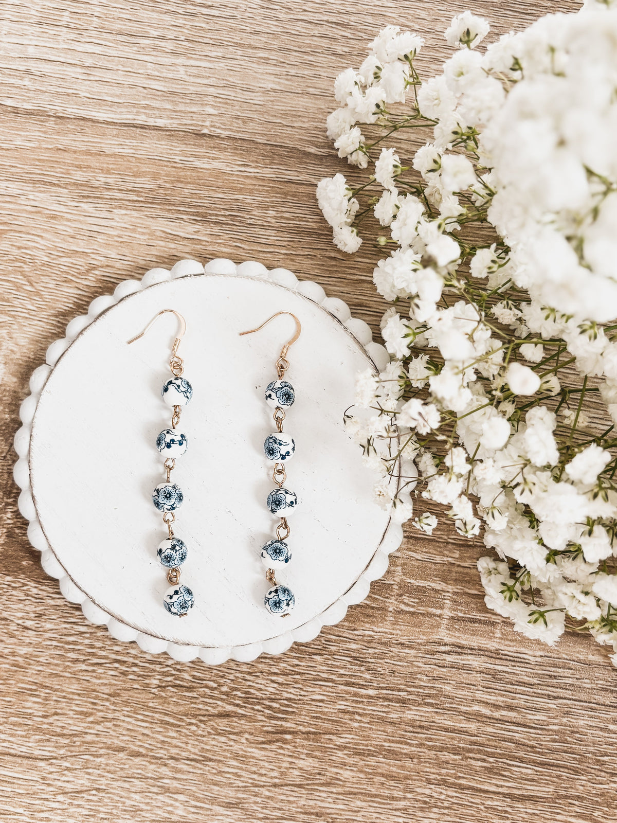 Blue porcelain bead drop earrings with gold-tone hooks, five-bead vertical design