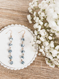 Blue porcelain bead drop earrings with gold-tone hooks, dangling five beads each