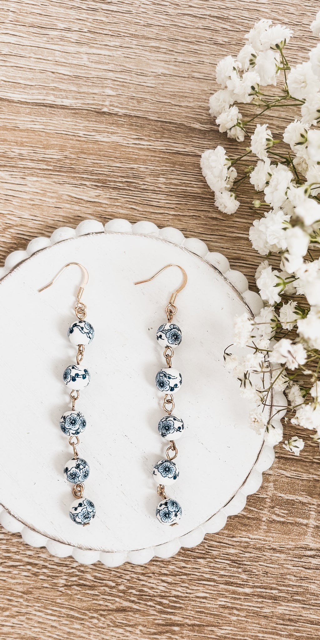 Blue porcelain bead drop earrings with gold-tone hooks; five beads on each earring