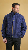 Navy quilted bomber jacket with stand collar, snap buttons, ribbed cuffs and hem
