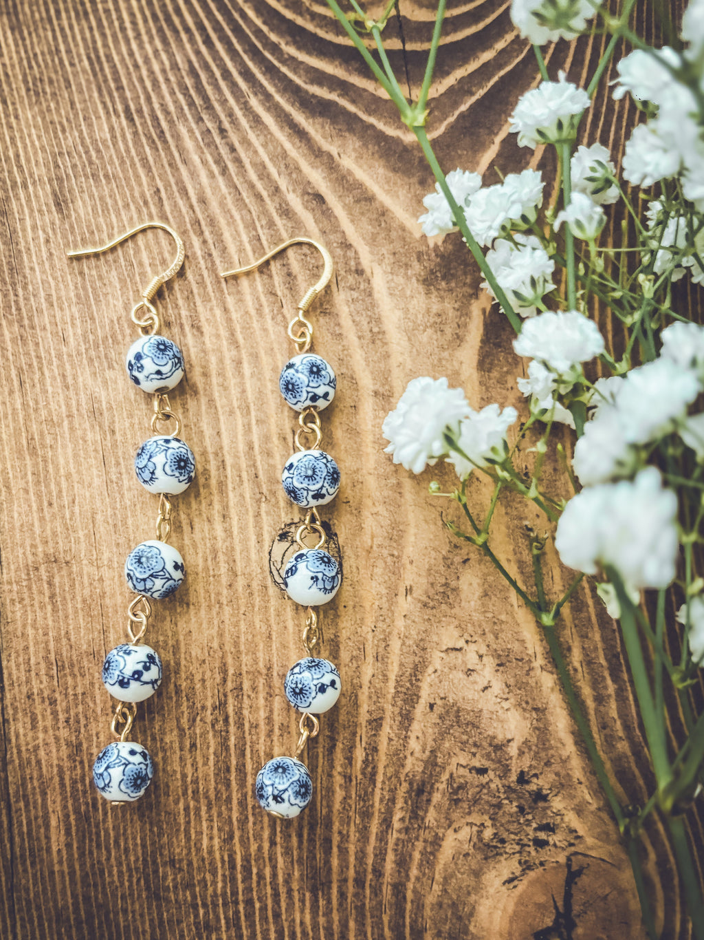 Blue porcelain bead drop earrings with gold-tone hooks, spaced round bead drops