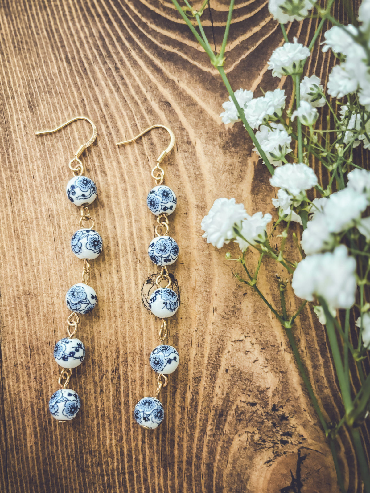 Blue porcelain bead drop earrings with gold-tone hooks, spaced round bead drops