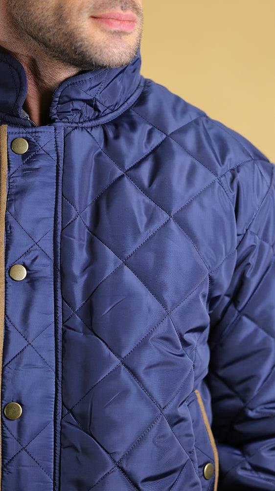 Navy quilted bomber jacket close-up with stand collar and gold-tone snap buttons