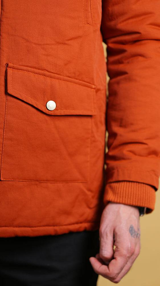 Orange bomber jacket front pocket with snap button and ribbed sleeve cuff