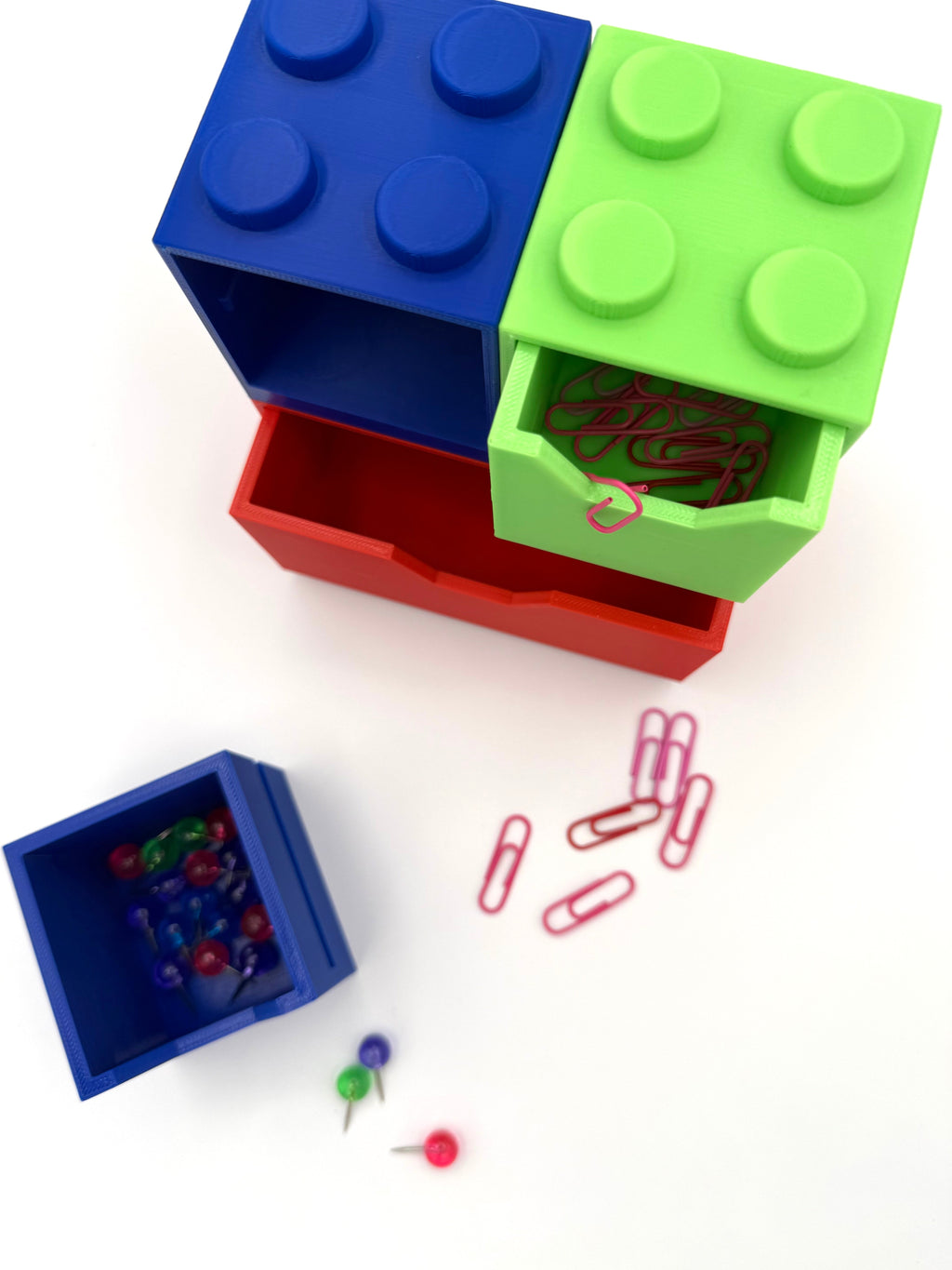 Stackable block desk organizer with blue top bin, green front bin, and red base