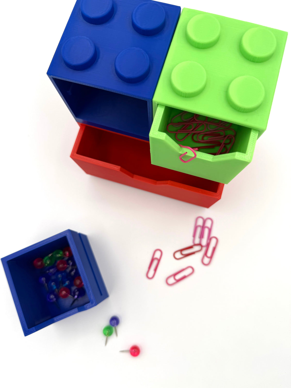 Stackable block desk organizer with blue top bin, green front bin, and red base