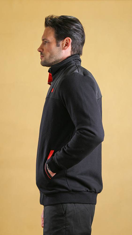 Black tech sweater, side profile with zip front and red trim at sleeves