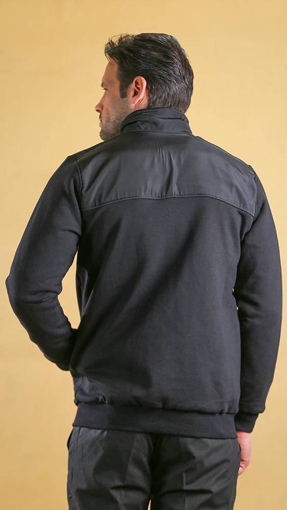 Black tech sweater back view with mock neck and red sleeve panel accents