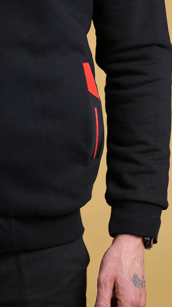 Black tech sweater sleeve with red vertical accent and ribbed cuff