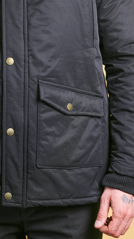 Black bomber jacket front pocket with snap button and ribbed cuffs
