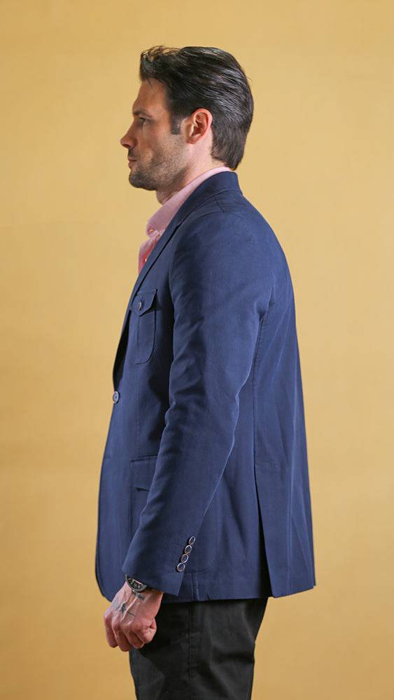 Men's navy bespoke blazer profile view with flap pockets and single-breasted styling