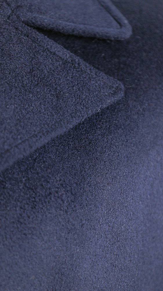 Navy overcoat fabric close-up with textured weave.