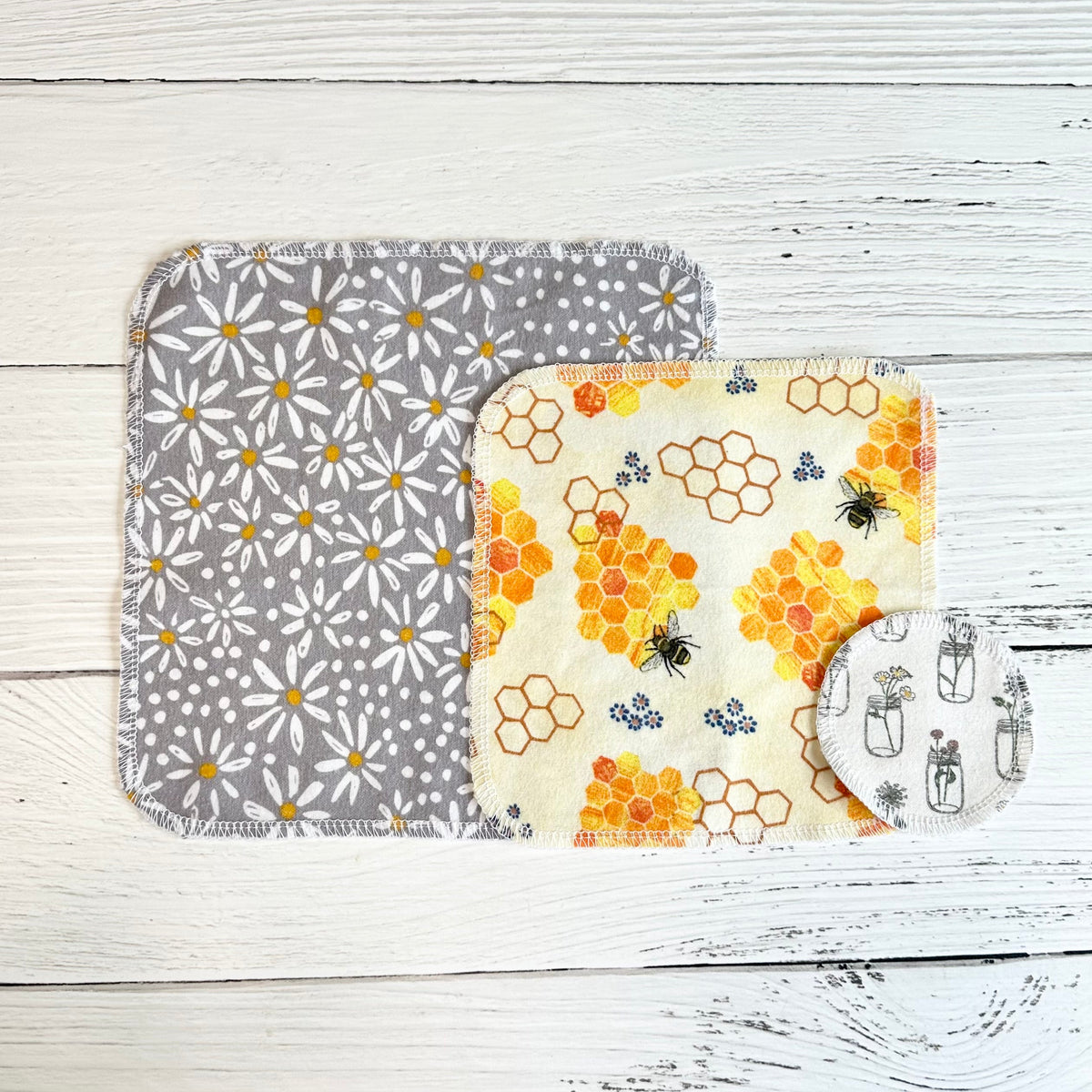 Reusable paper towels folded stack: gray daisy and honeycomb bee patterns