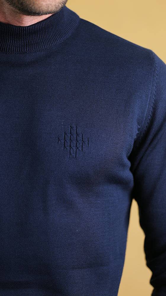 Cobalt blue sweater with small embroidered logo on the chest and ribbed neckline.