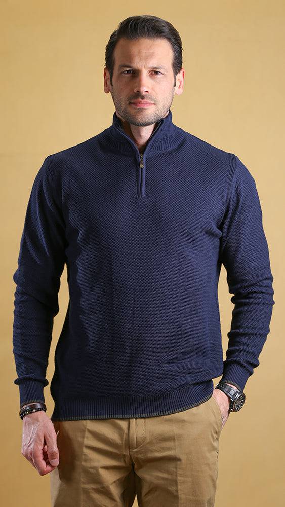Navy quarter-zip sweater with half-zip placket and ribbed waistband, worn