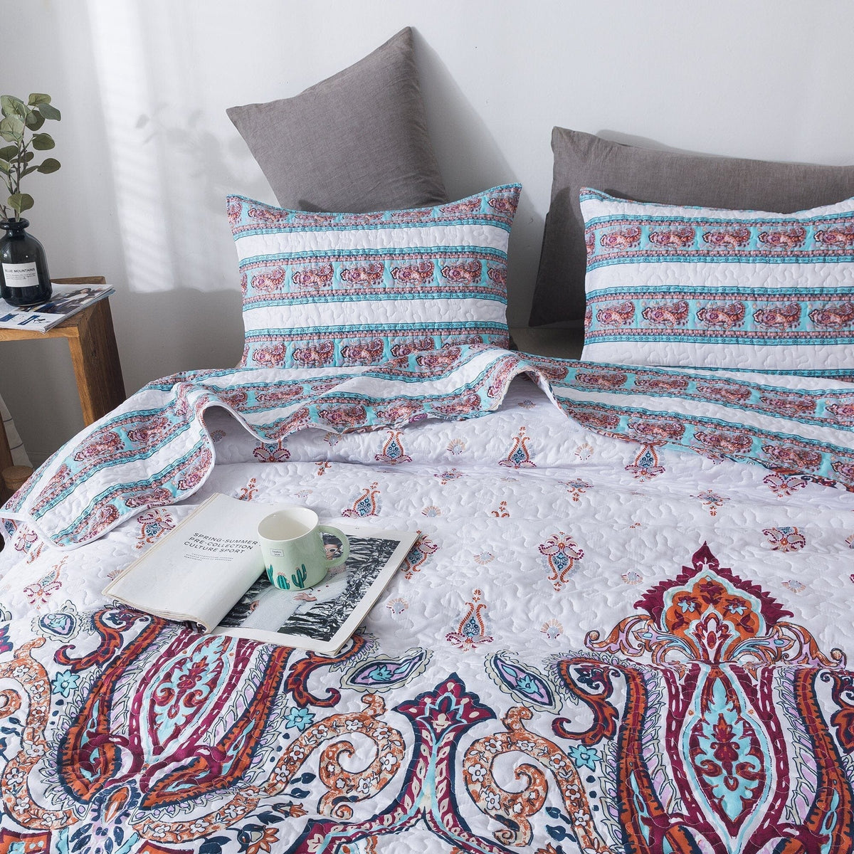 White paisley duvet and pillow shams with blue and burgundy ornamental band pattern