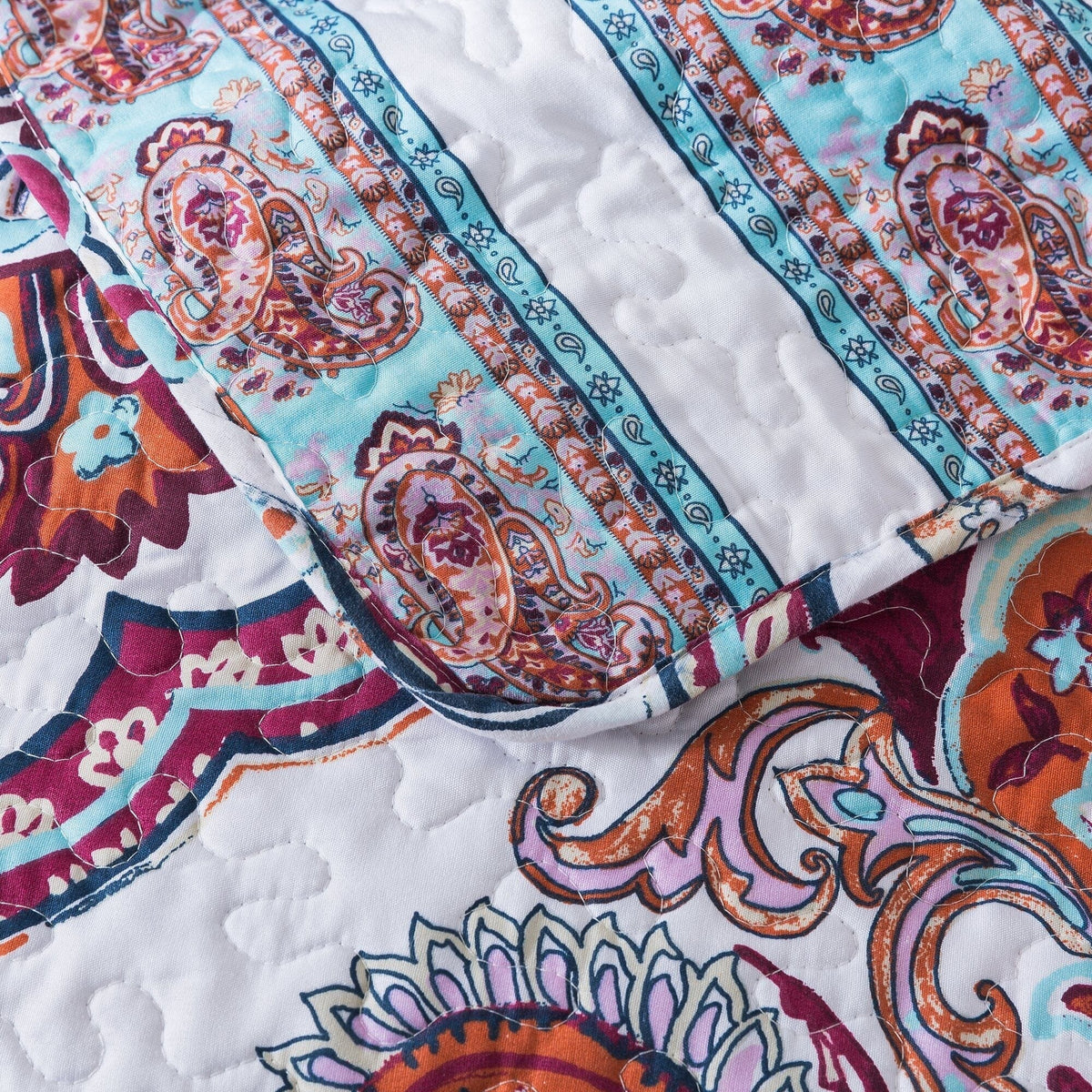 Paisley quilt with blue border stripes and floral medallion motifs on white