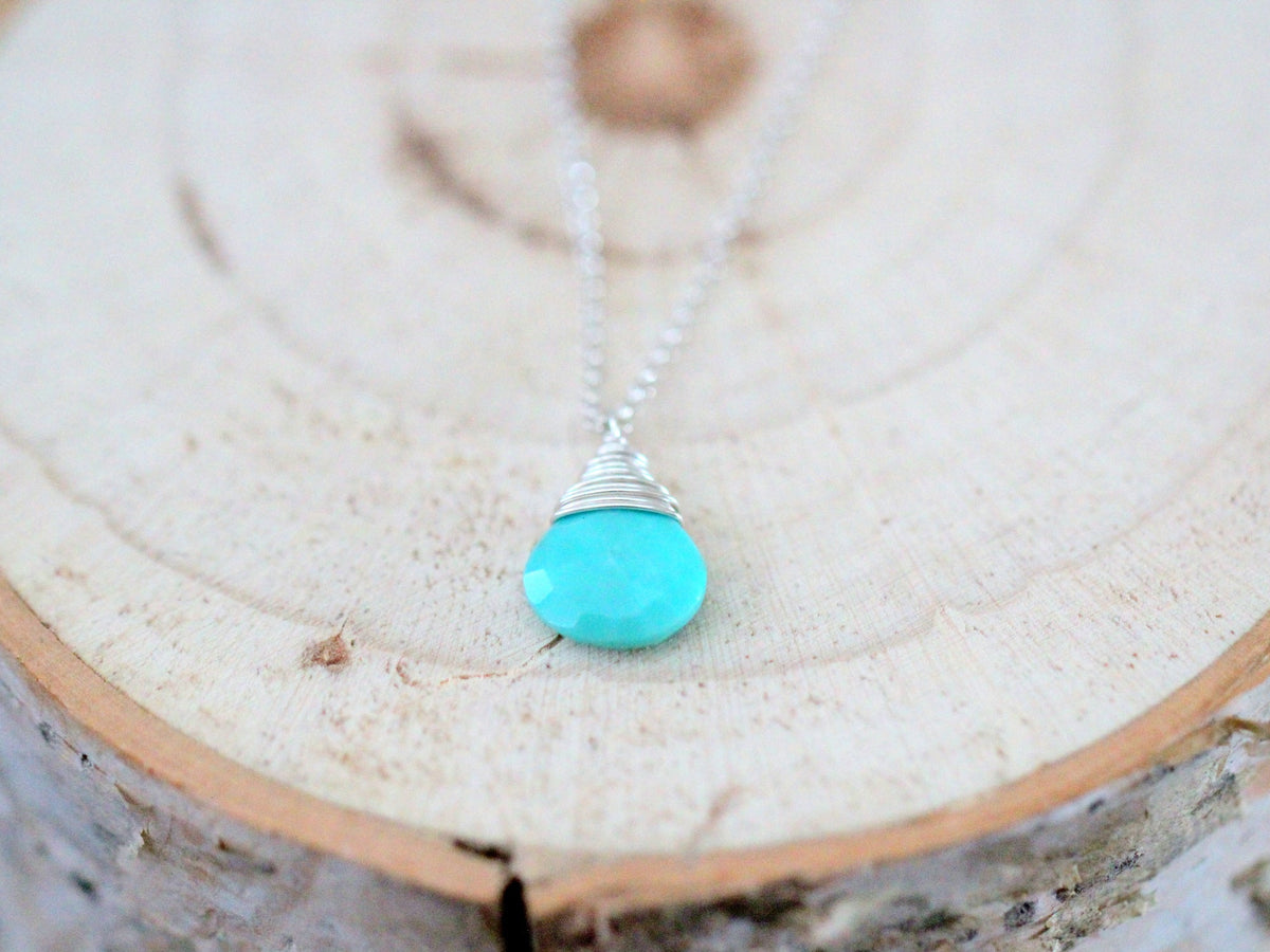 Turquoise solitaire pendant necklace on a delicate silver-tone chain with teardrop charm