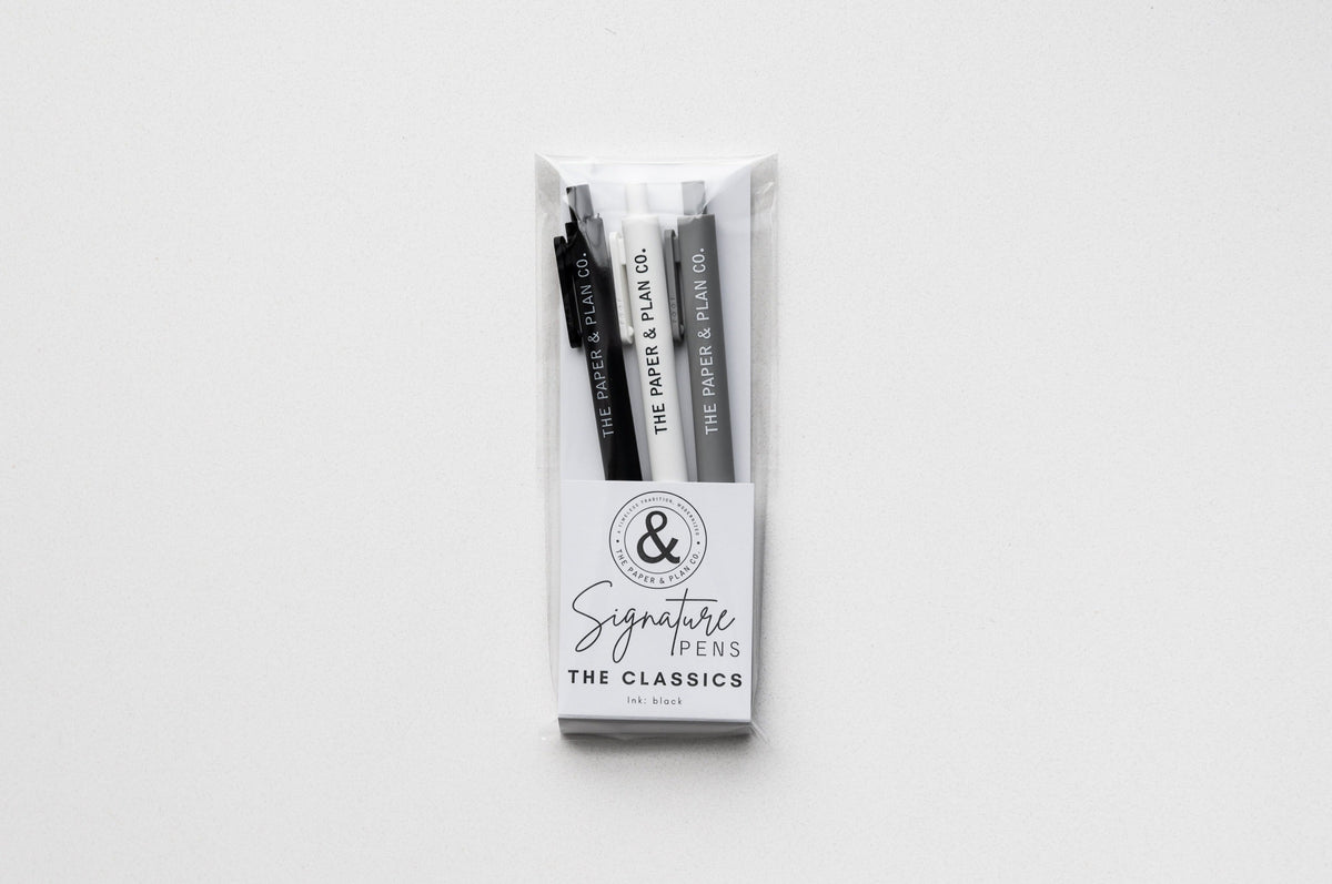 Clear plastic pack containing three black and gray pens labeled “Signature Pens”