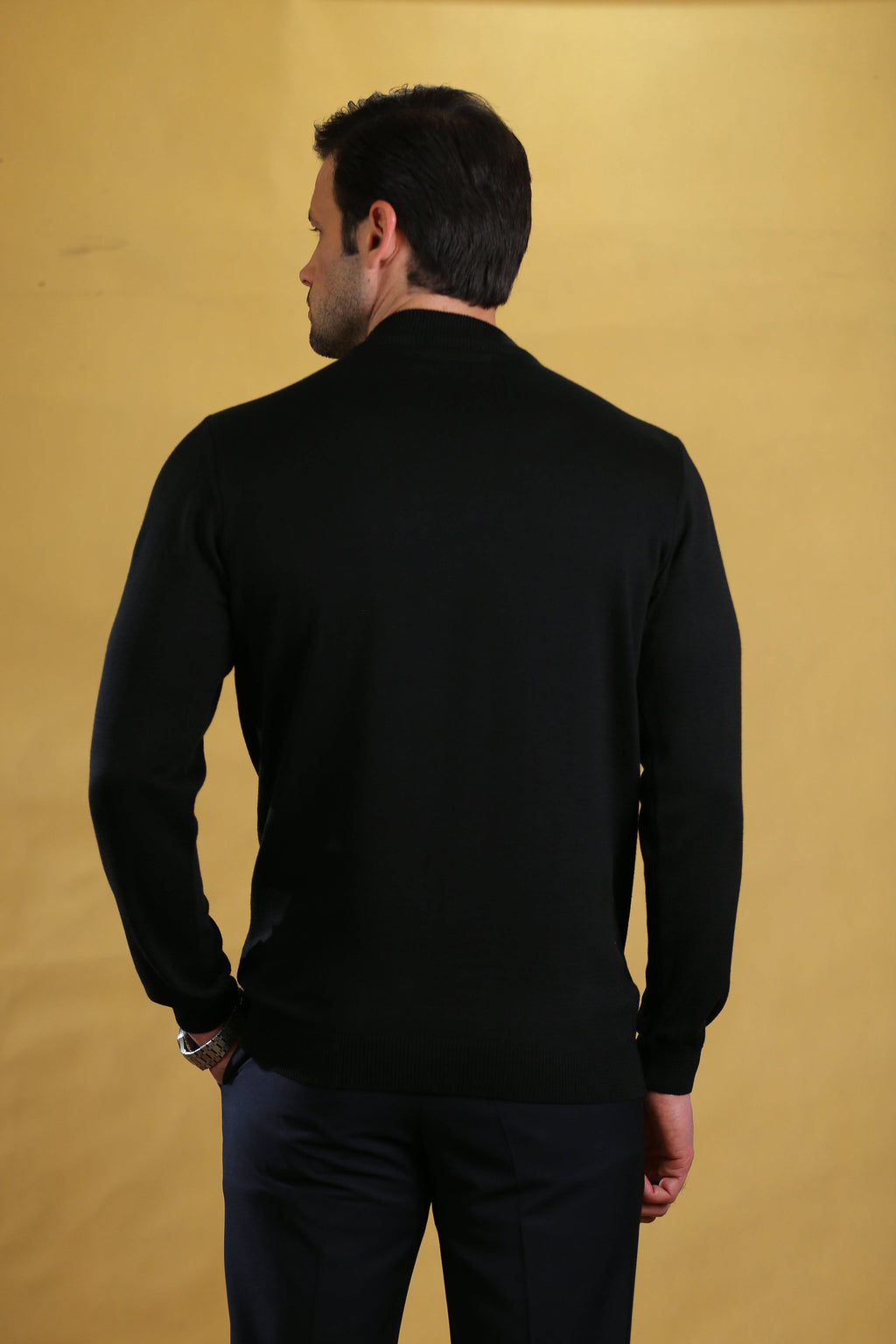 Black crewneck sweater back view with long sleeves and ribbed cuffs