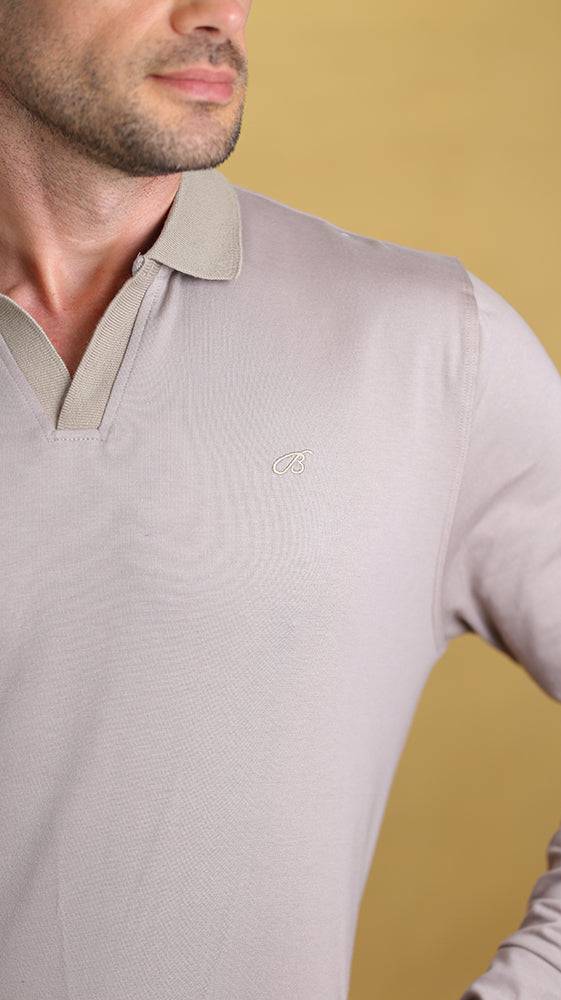 Cream long-sleeve polo close-up of collar and small chest logo