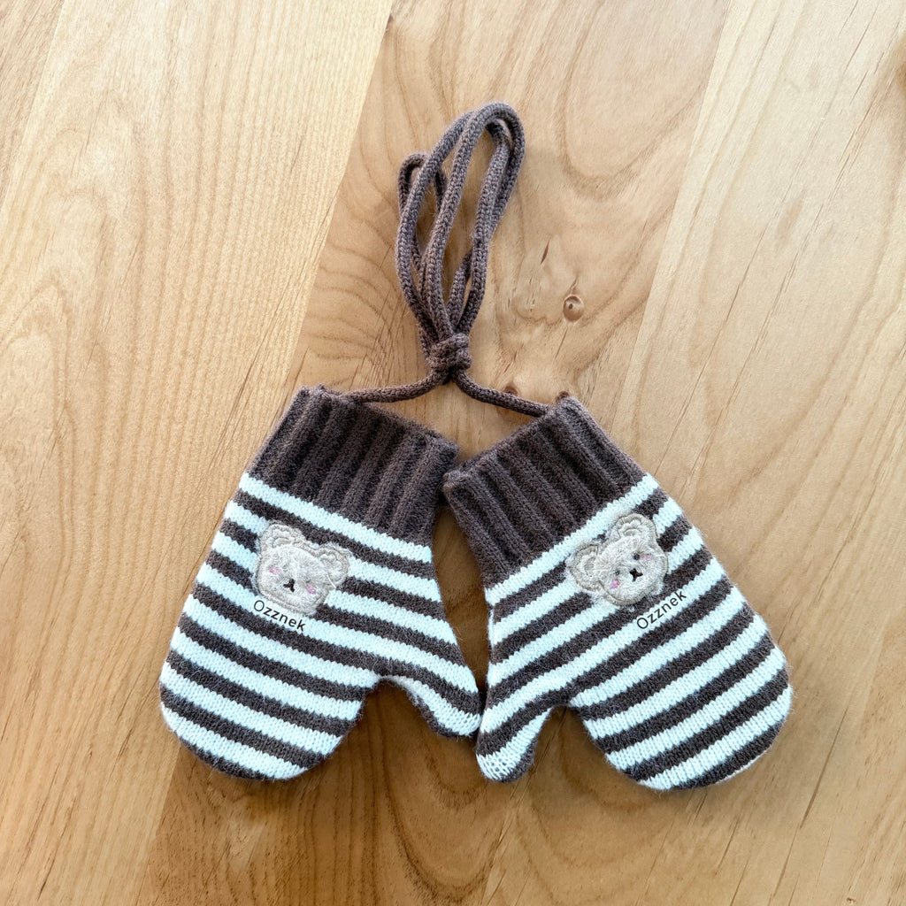 Kids winter mittens with dark gray and white stripes, bear patches, and tie strings