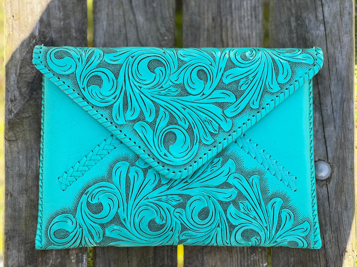 Hand-tooled leather crossbody & clutch bag, turquoise with swirling floral emboss and stitched trim