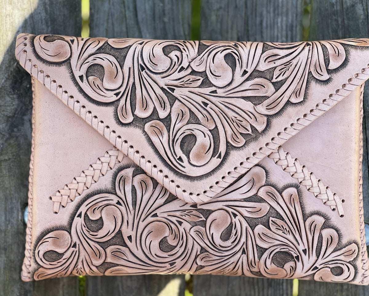 Hand-tooled leather crossbody clutch bag, pale tan with floral embossing and braided trim