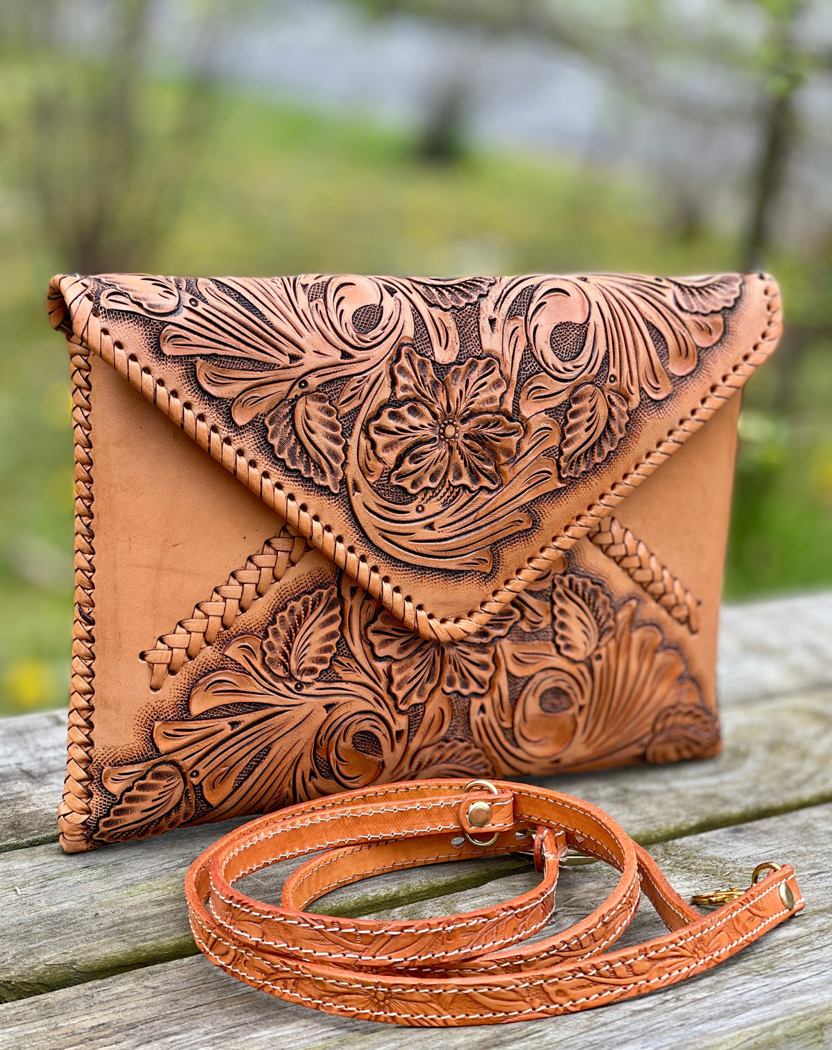 Hand-tooled leather crossbody clutch bag with floral embossing, tan and brown