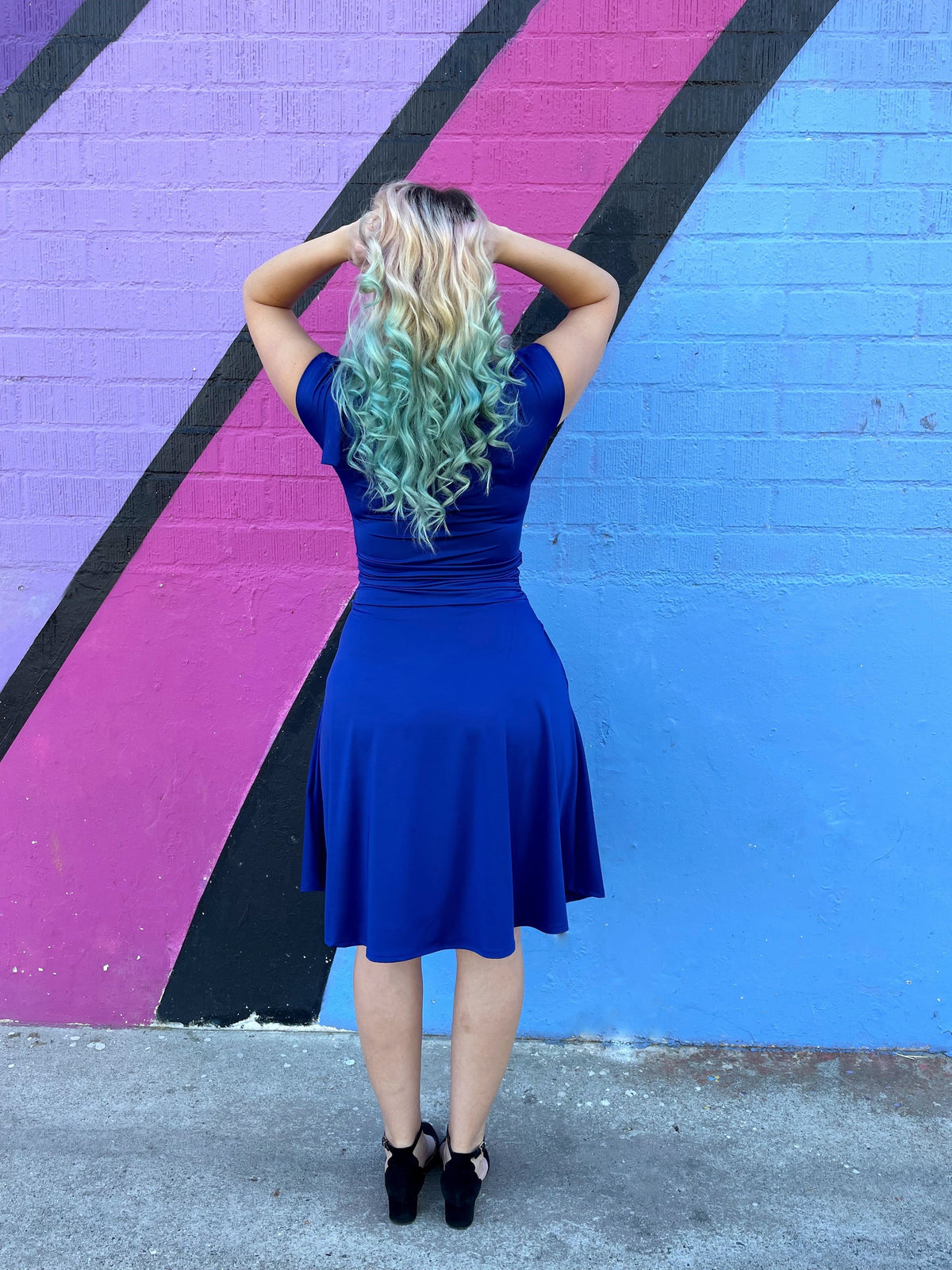 Back view of royal blue fit-and-flare dress with gathered ruched waist