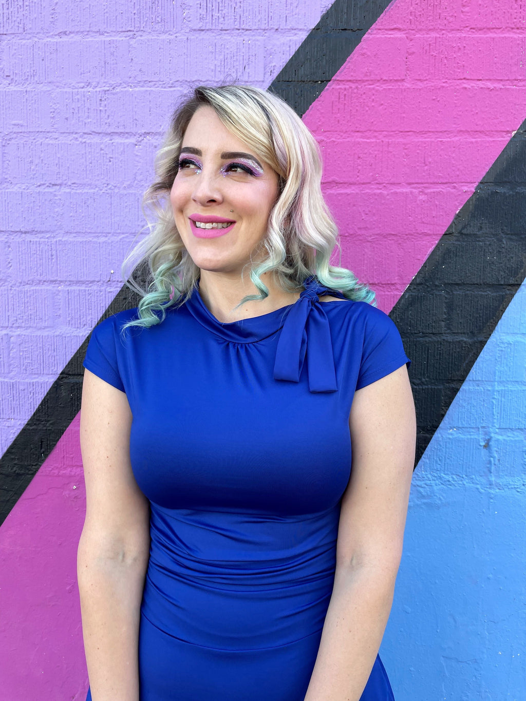 Royal blue dress with bow at neckline and ruched waist, short cap sleeves