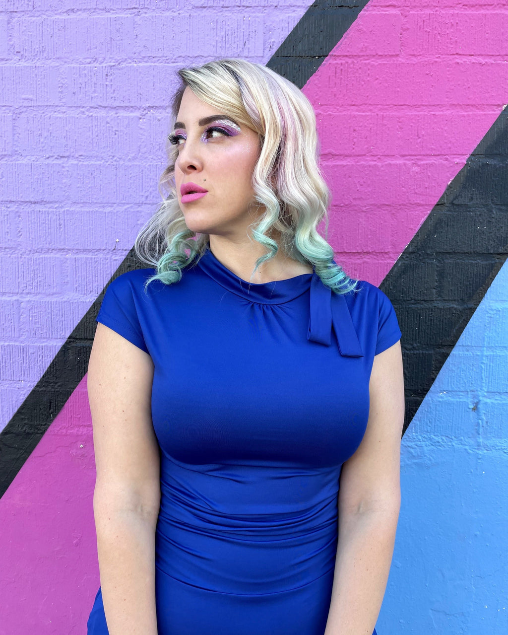 Royal blue dress close-up with bow neckline and draped ruched waist