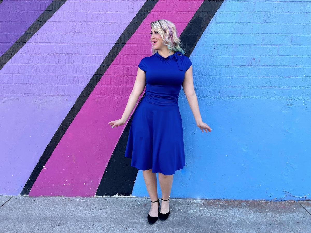 Royal blue fit-and-flare dress, knee-length skirt with ruched waist and bow collar