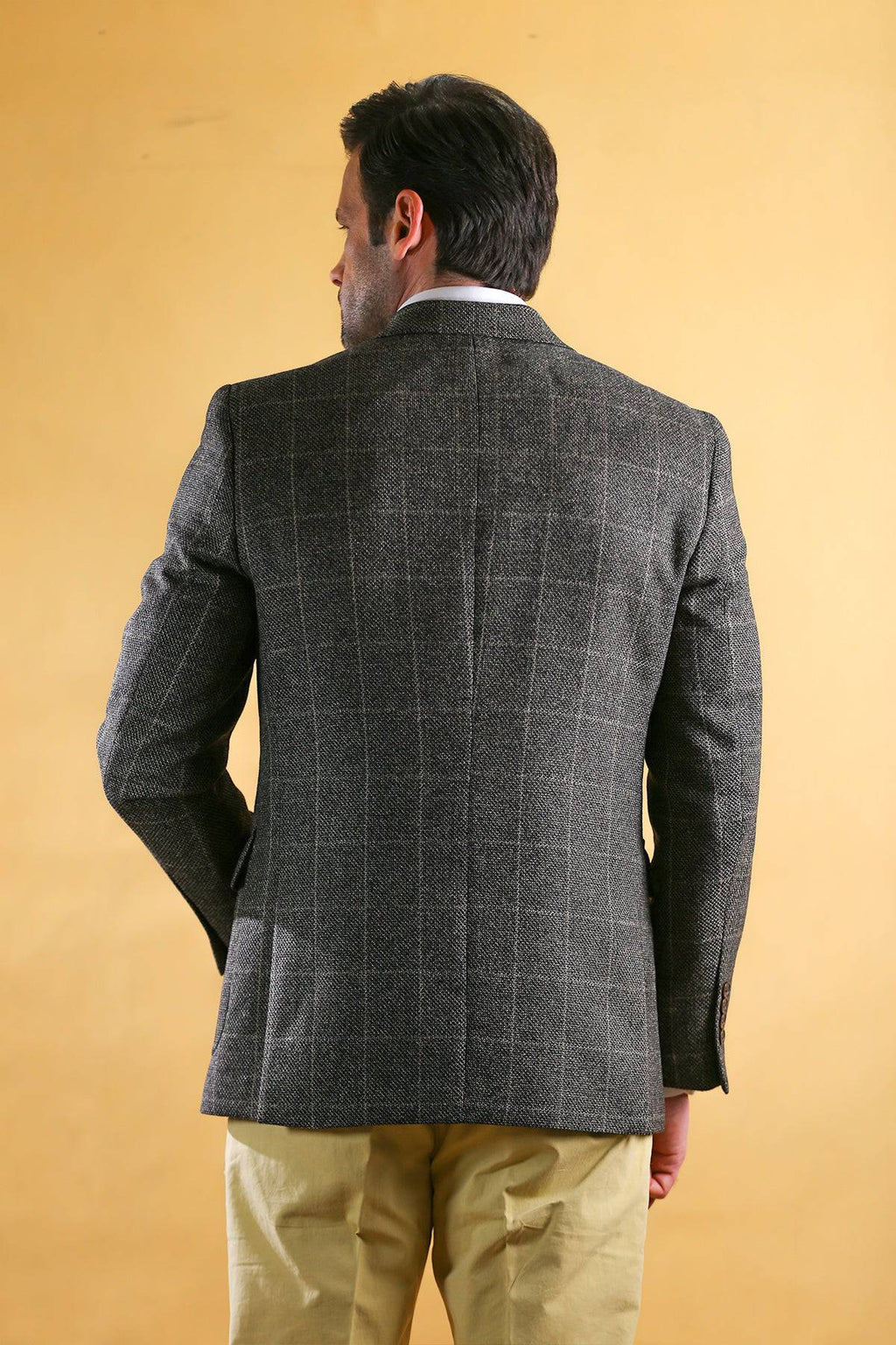Men's vintage blazer in dark gray check texture, back view with center seam and vent.