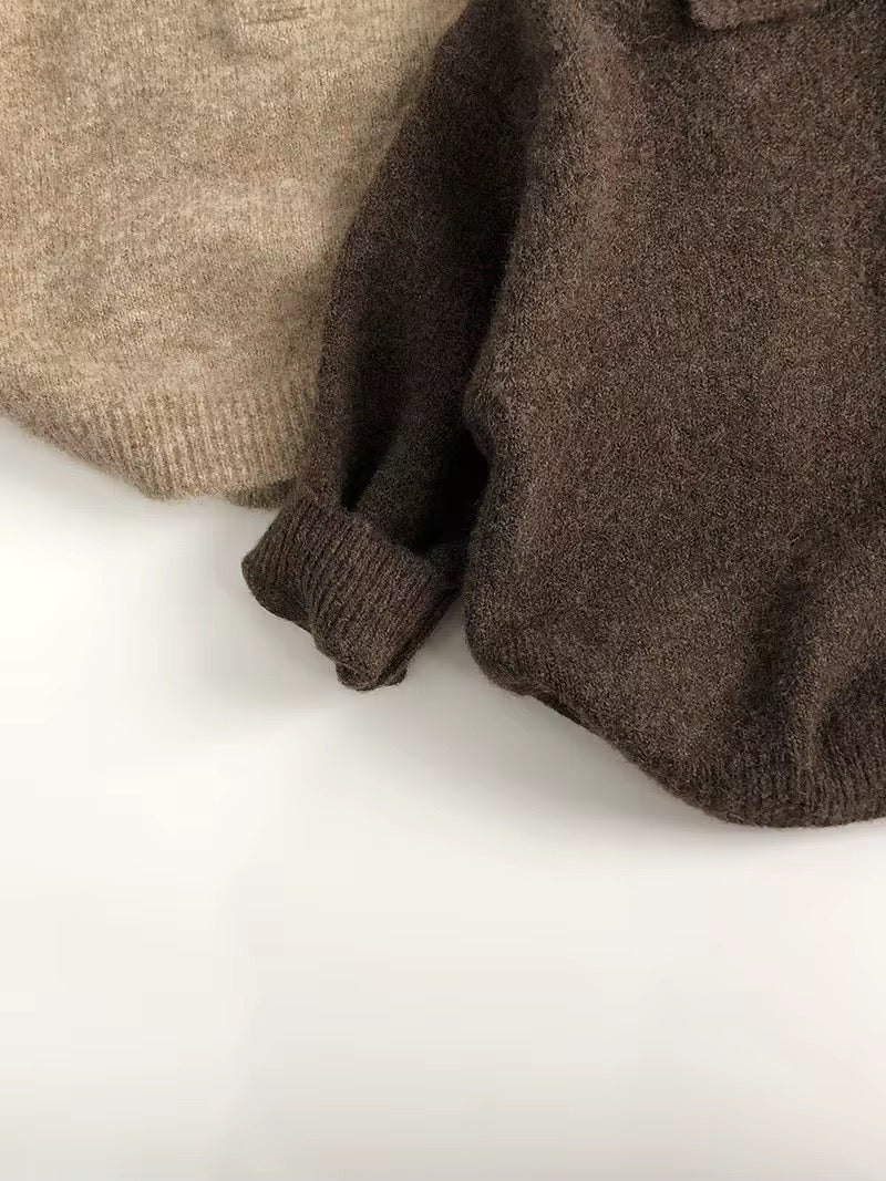 Toddler knit sweater close-up, ribbed cuffs and hem in brown