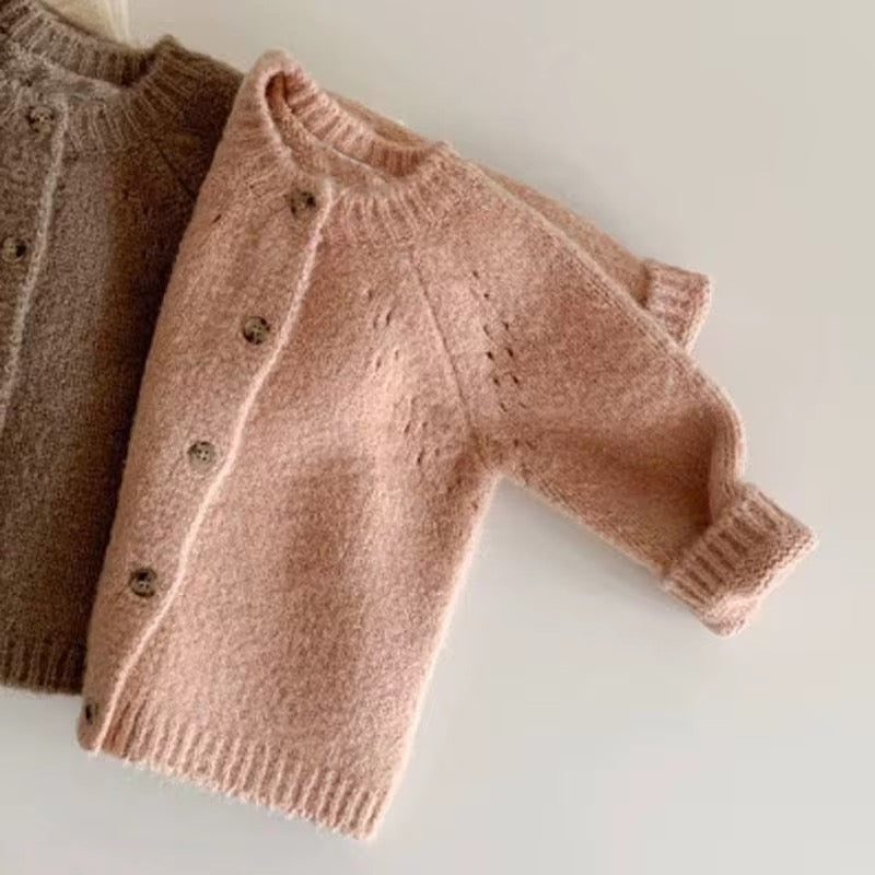 Close-up: kids' button-front knit cardigans in taupe brown and blush pink