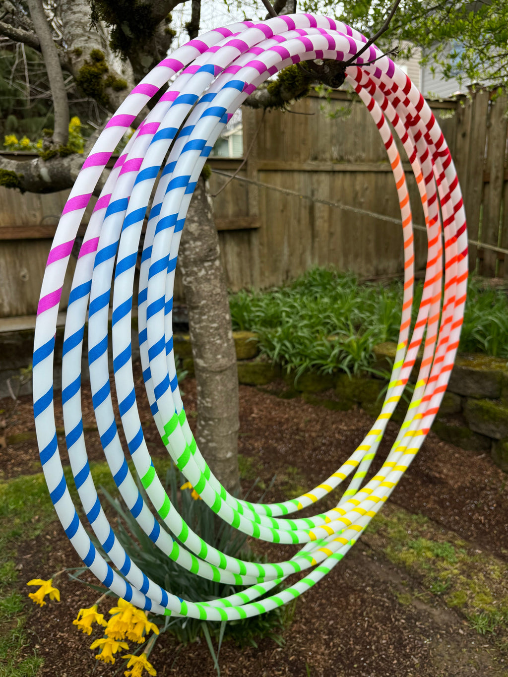 Beginner hula hoop with rainbow spiral gaffer tape ribbon outdoors