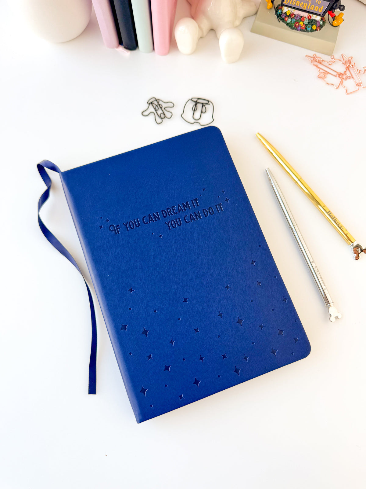 Blue embossed notebook with inspirational quote and star pattern, ribbon bookmark