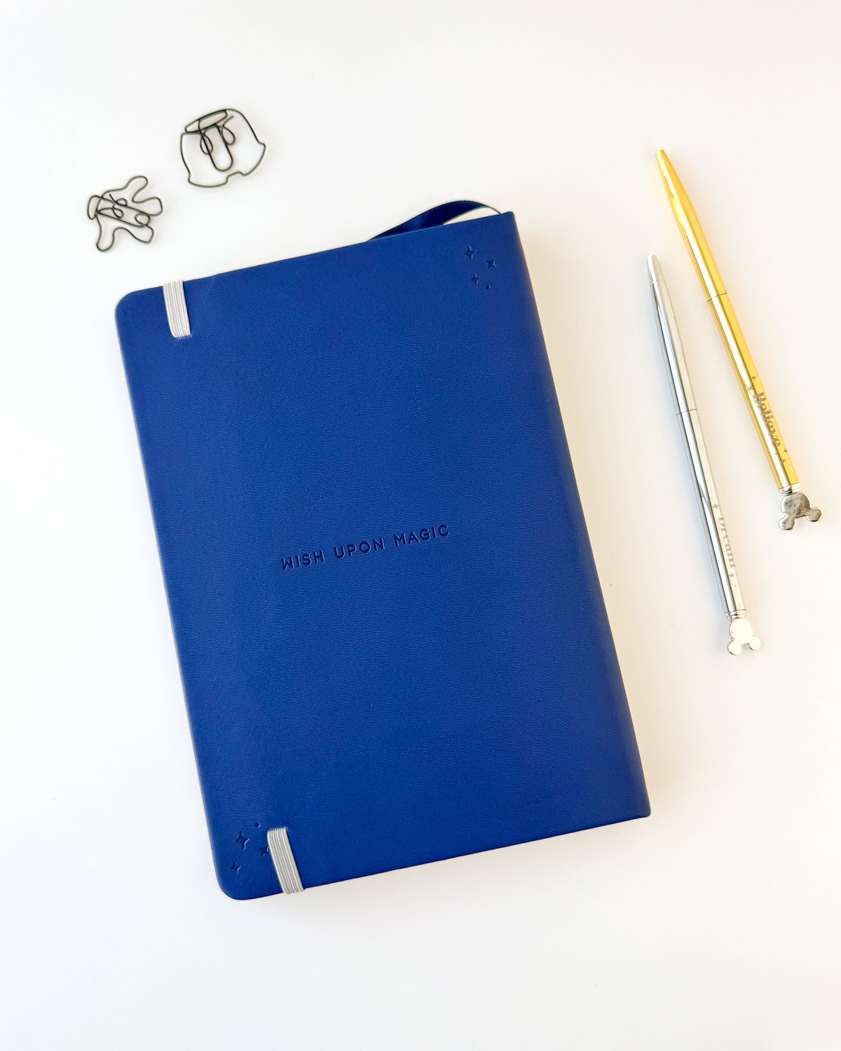 Blue embossed notebook with 'WISH UPON MAGIC' text and ribbon bookmark