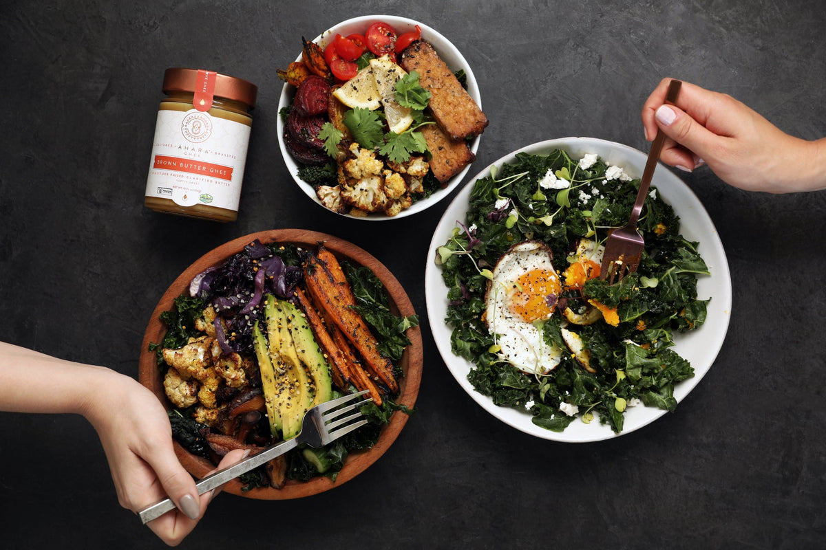 Ahara Rasa brown butter ghee jar beside plated meal with herbs and spices.