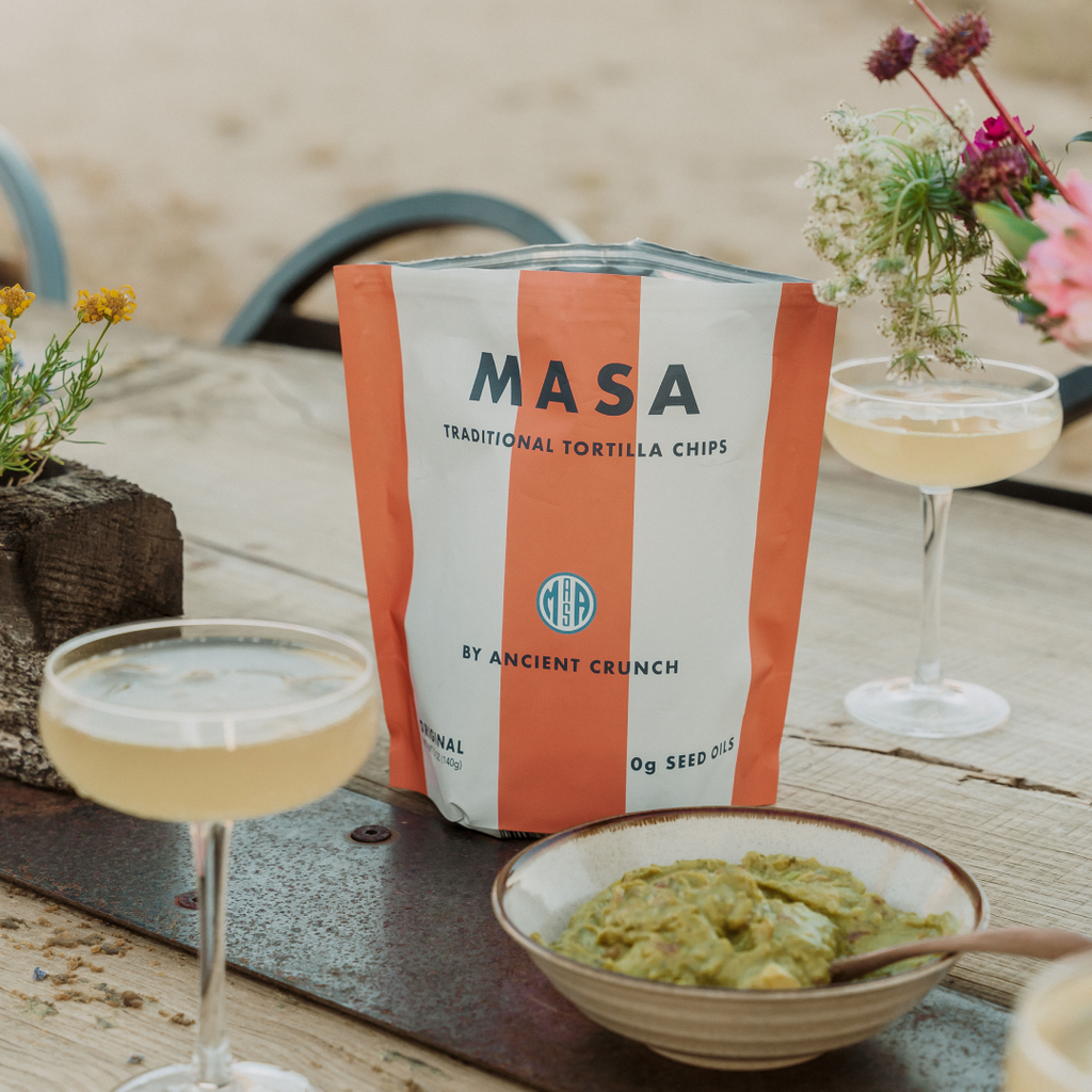 MASA Original tortilla chips bag on a table with bowls of dip