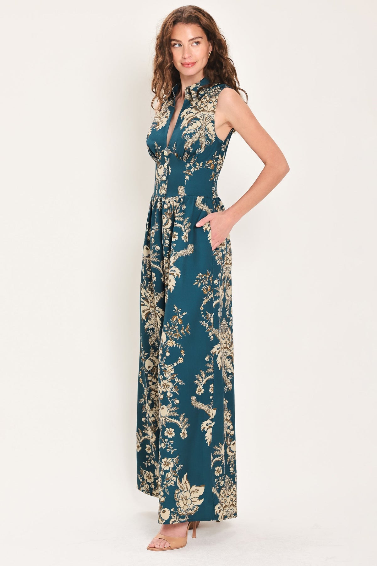 Teal sleeveless collared wide-leg jumpsuit with V-neck and gold floral print, side view