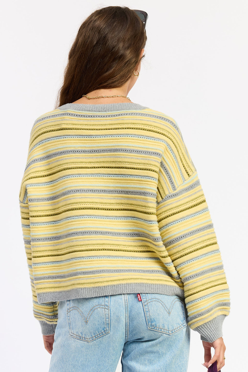 Back view of striped button cardigan in yellow-gray multi stripes, ribbed hem