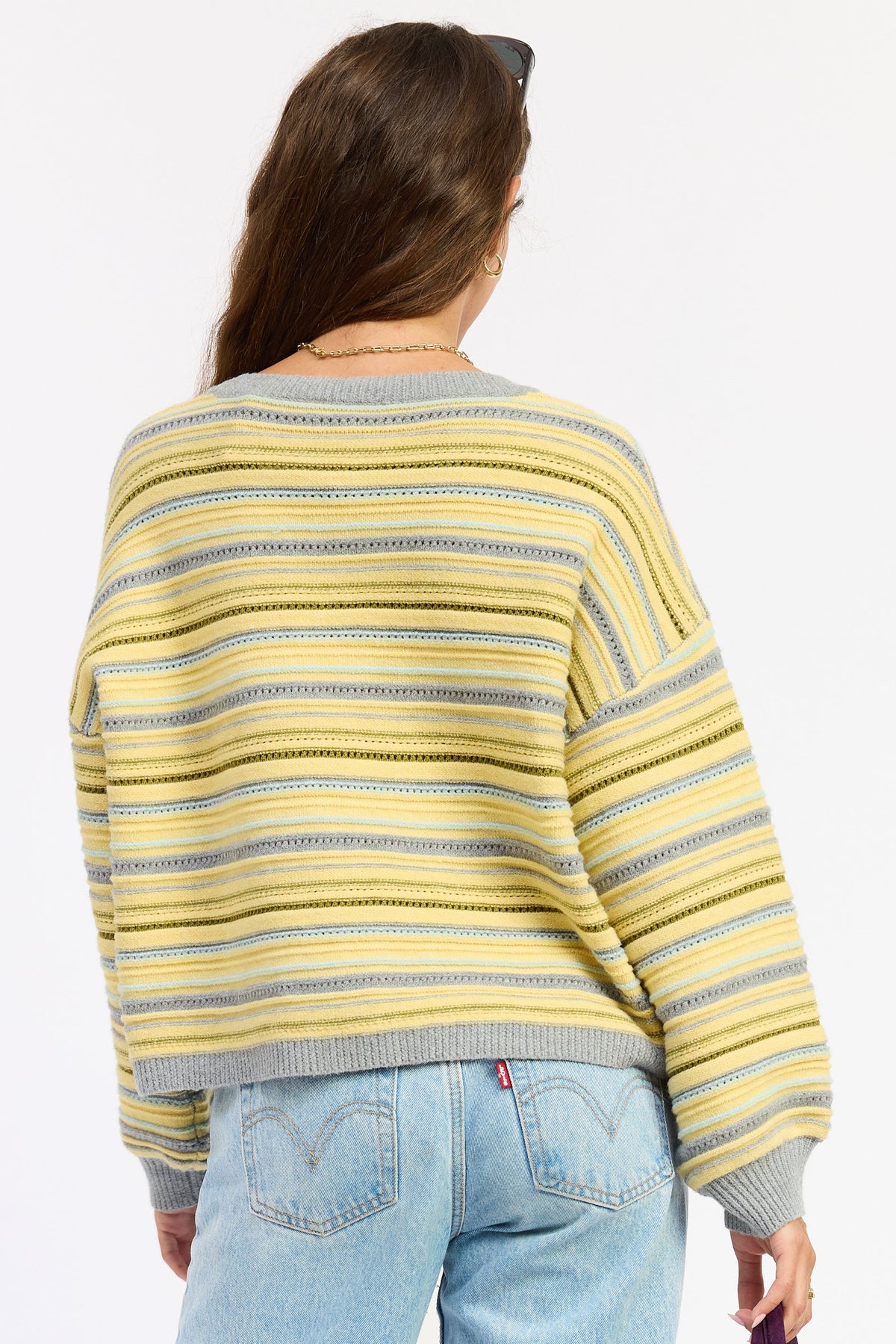 Back view of striped button cardigan in yellow-gray multi stripes, ribbed hem