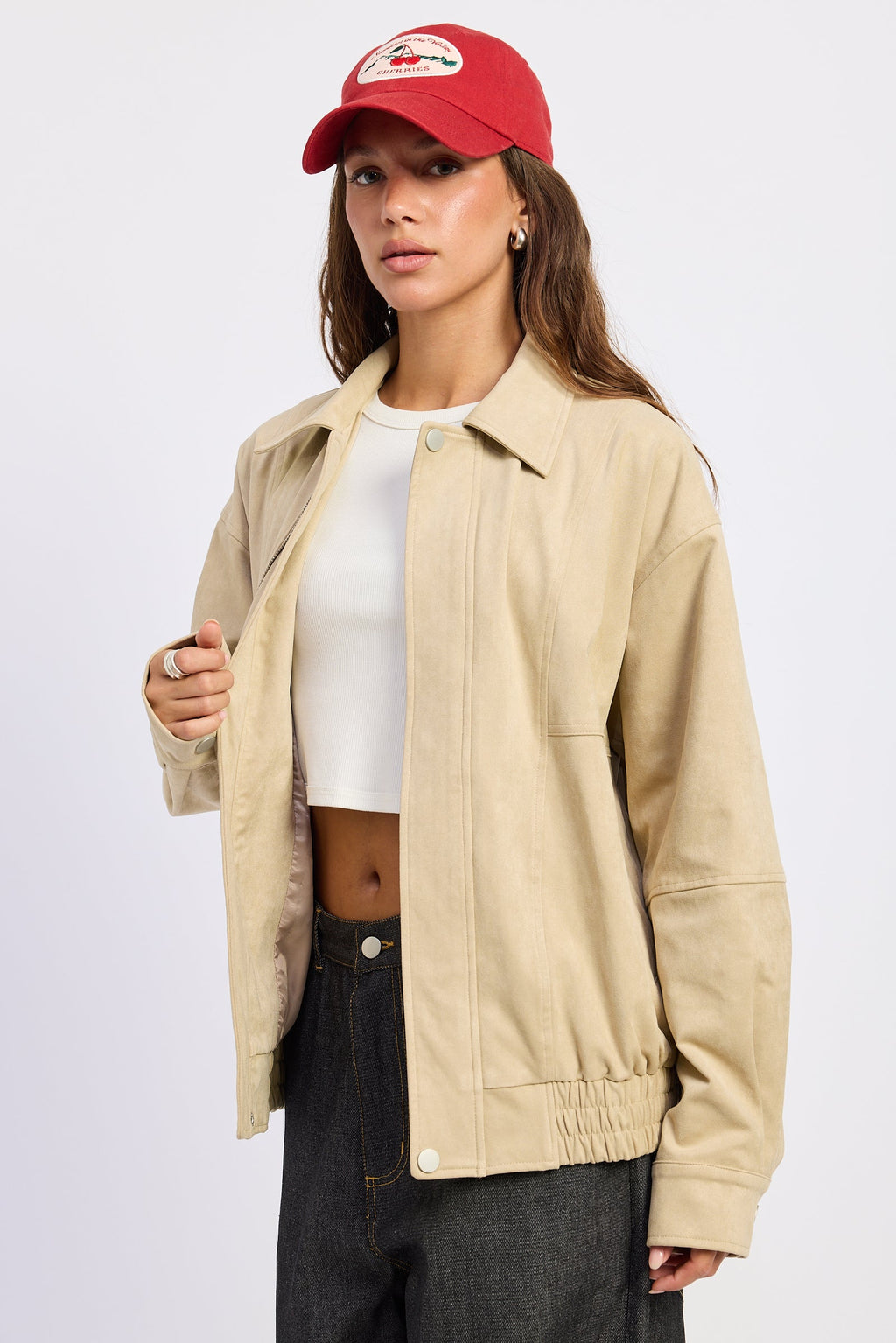 Light beige bomber jacket with stand collar, chest pocket, and elastic cuffs
