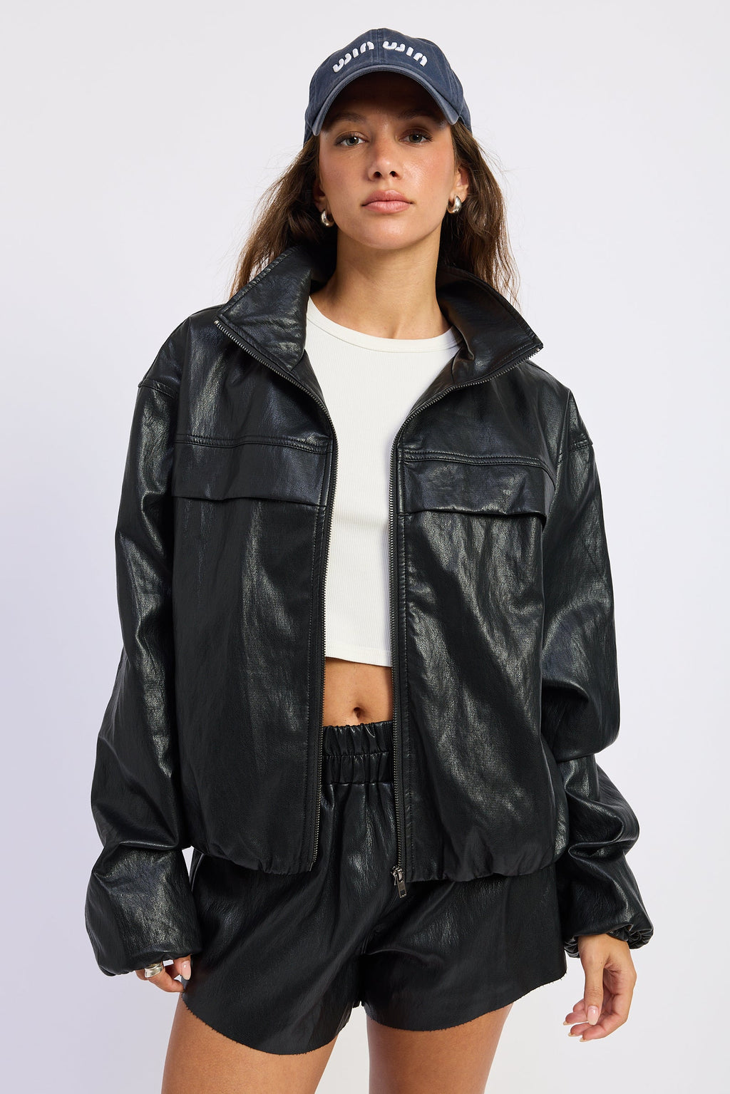 Black leather-look jacket with flap pockets, stand collar, and zip front