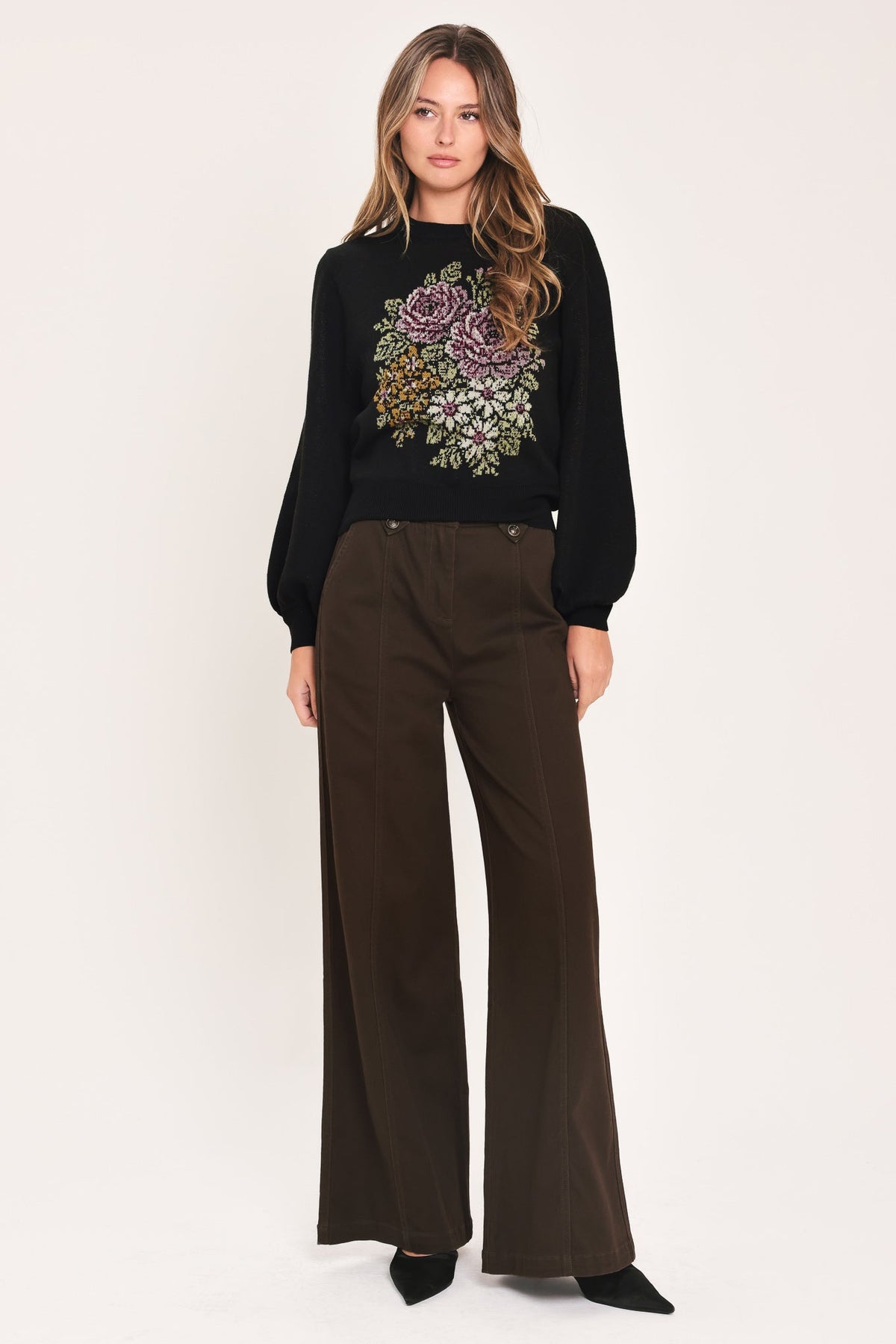 Black balloon-sleeve sweater with floral chest motif and crew neck