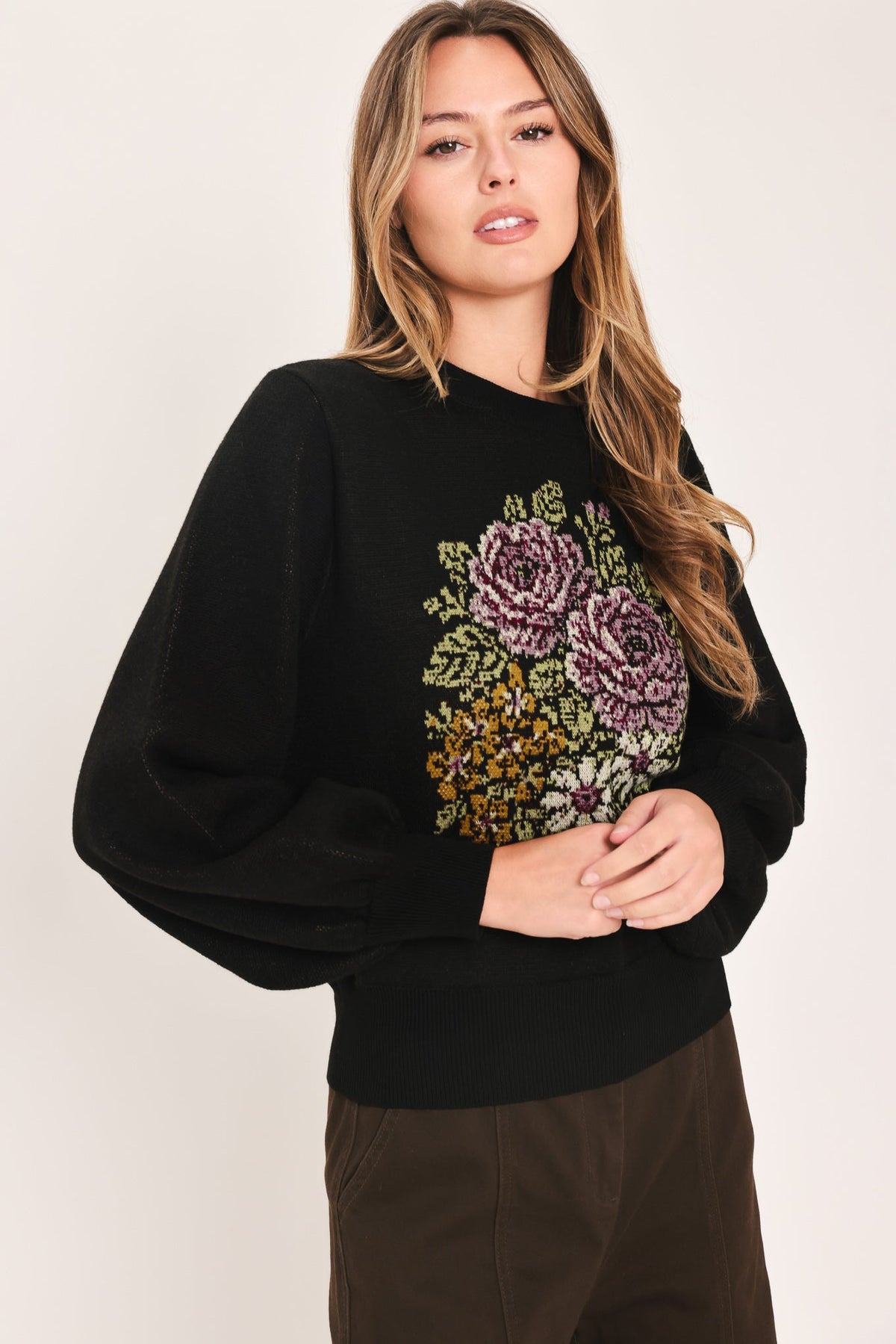 Black balloon-sleeve sweater with floral pixel embroidery on the front