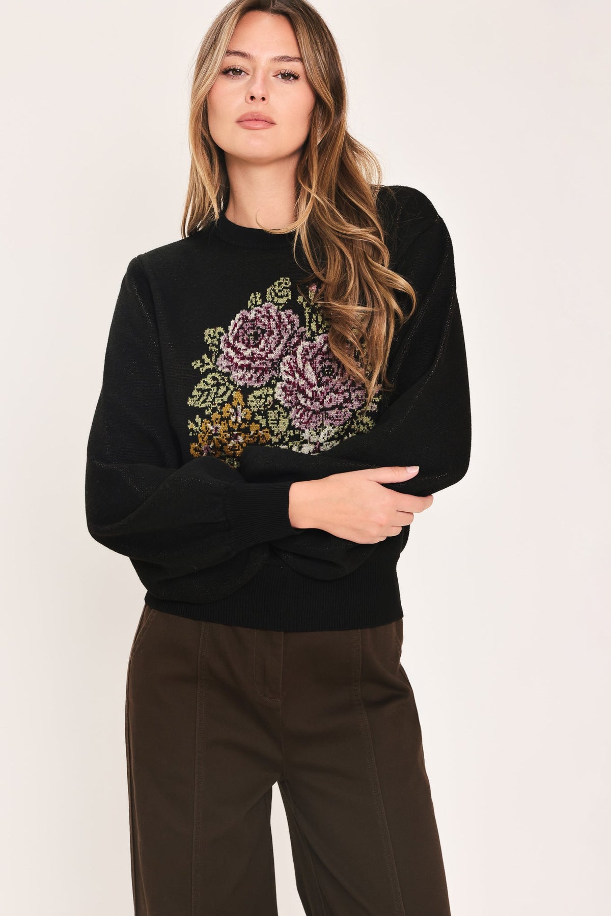 Black balloon-sleeve sweater with floral pixel embroidery at chest