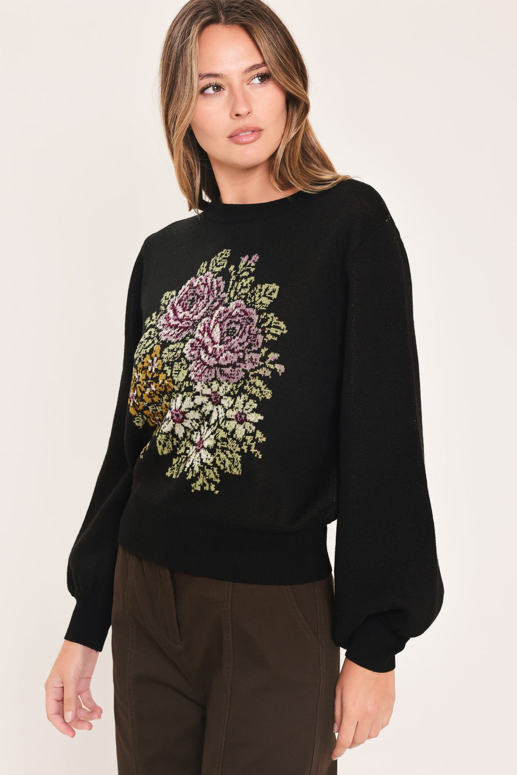 Black crewneck sweater with floral pixel embroidery at center front